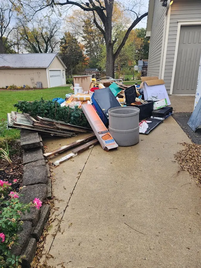 Dumpster being loaded with debris for Roofing Dumpster Rental in Freeport